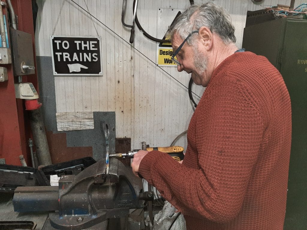 Keith fabricates a new bracket to hold the steam heating pipe on the front of GWR No. 4979 Wootton Hall